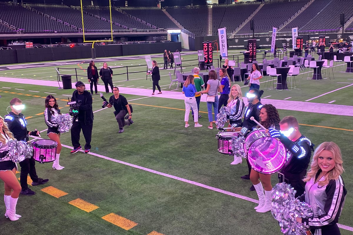 Cheerleaders and drummers performing on football field at stadium event in Las Vegas